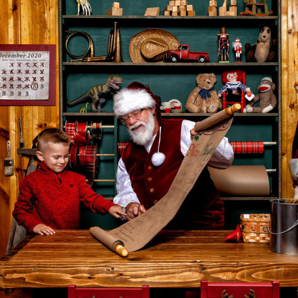 little boy with Santa in Santa's workshop